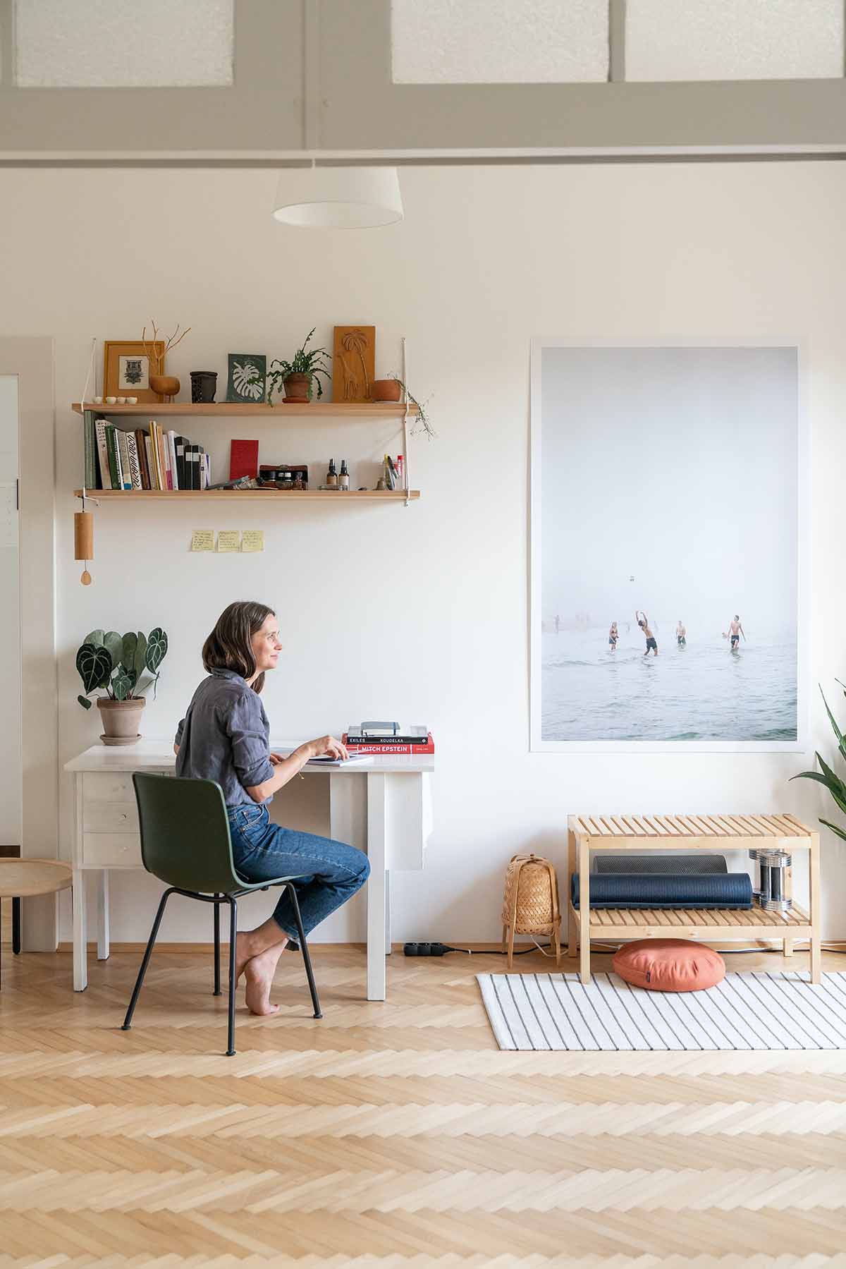 women staring at wall art piece in house